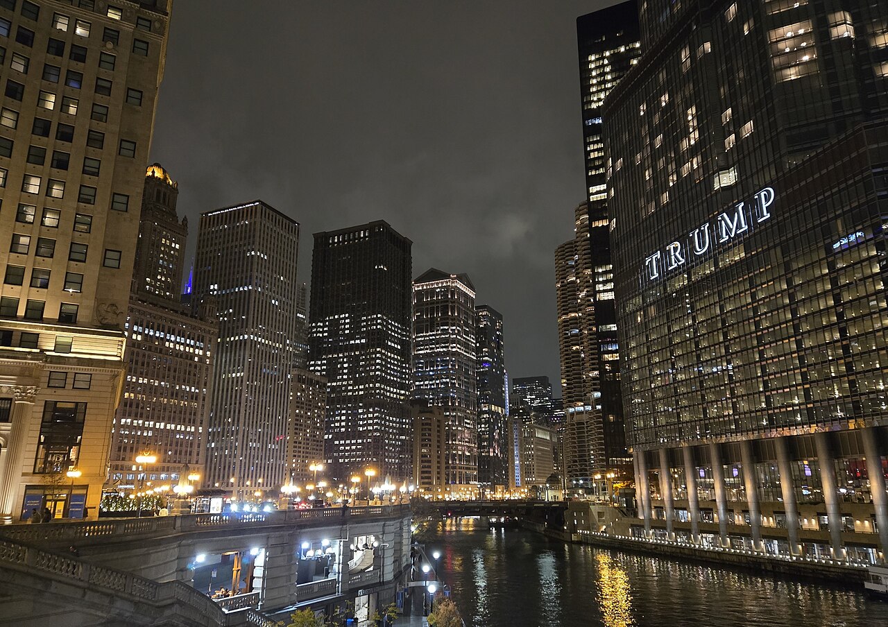 Chicago Riverwalk and downtown skyline illuminated at night.
